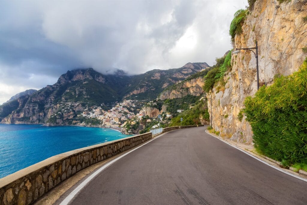 Scenic coastal road winding along Mediterranean cliffs