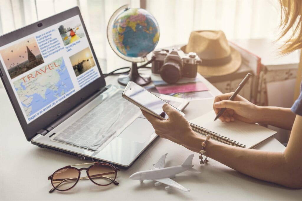 Traveller researching cruise options with a laptop and globe