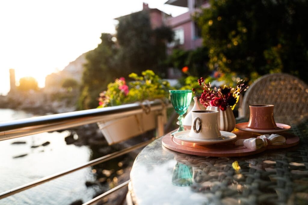 Quiet coffee table overlooking a Mediterranean coastal sunrise